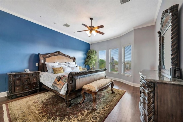 bedroom with crown molding, a textured ceiling, dark hardwood / wood-style floors, and ceiling fan