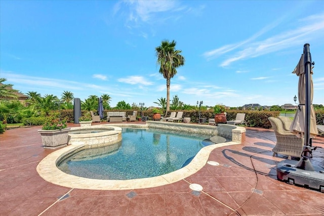 view of swimming pool with an in ground hot tub and a patio