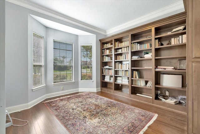 sitting room featuring wood-type flooring and crown molding