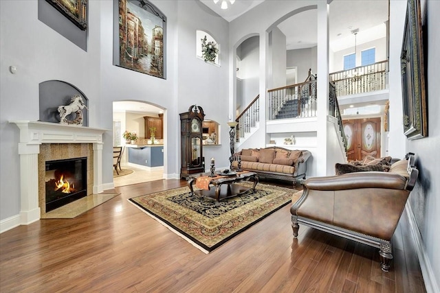 sitting room featuring hardwood / wood-style flooring and a towering ceiling