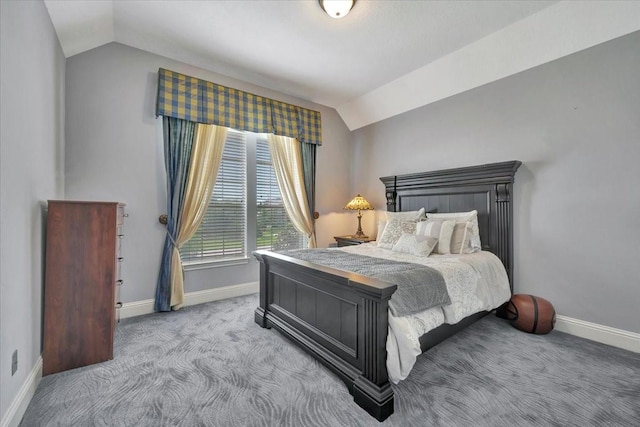 carpeted bedroom with lofted ceiling