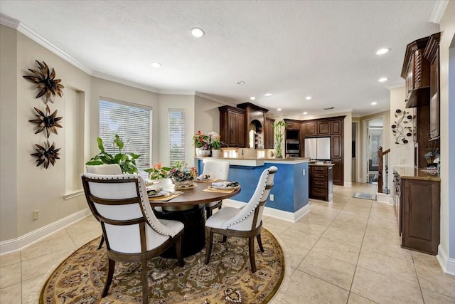 tiled dining space featuring ornamental molding