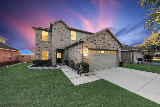 view of front of property with a garage and a yard