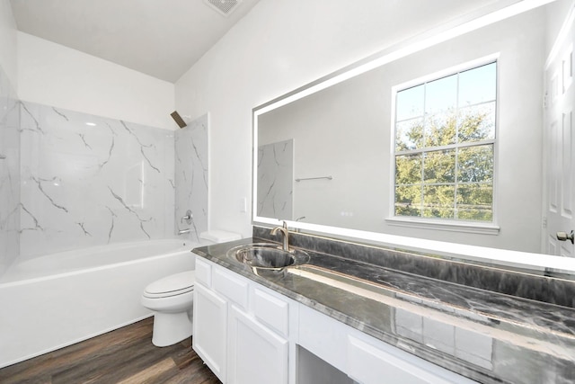 full bathroom with washtub / shower combination, vanity, toilet, and hardwood / wood-style floors