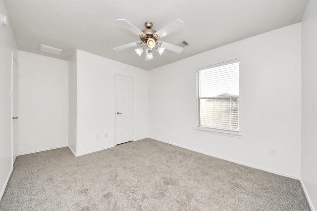 carpeted empty room featuring ceiling fan