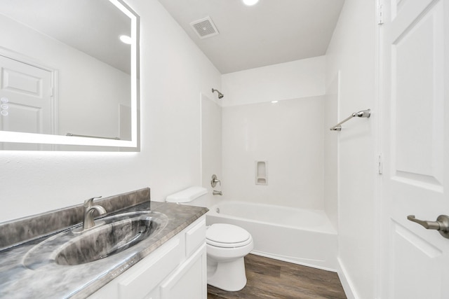 full bathroom featuring vanity, shower / washtub combination, hardwood / wood-style floors, and toilet