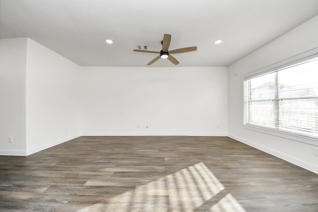 spare room with ceiling fan and dark hardwood / wood-style flooring