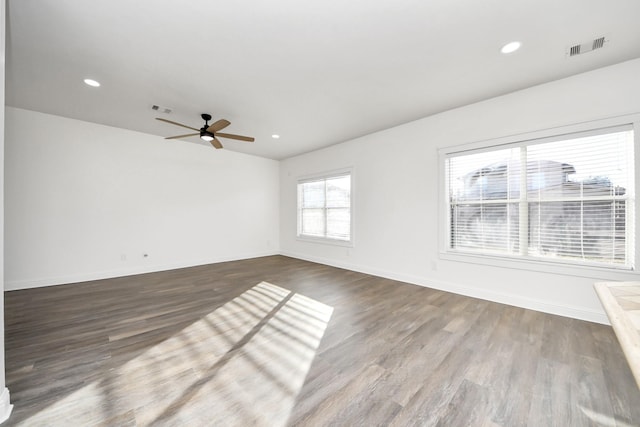 empty room featuring dark wood-type flooring and ceiling fan