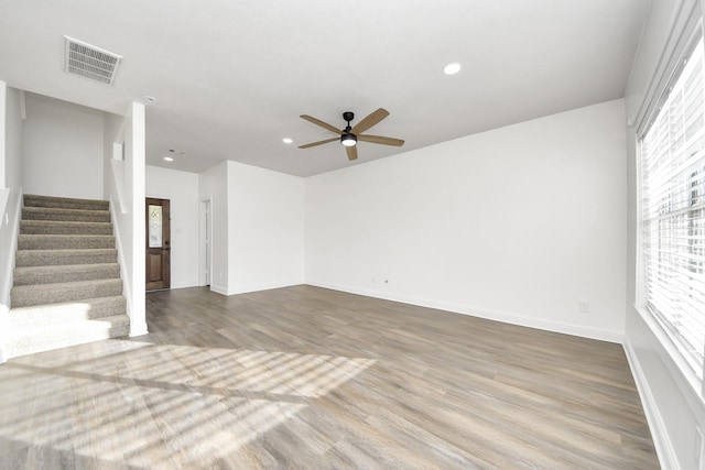 unfurnished living room with ceiling fan and light wood-type flooring