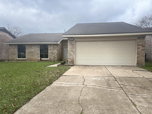 single story home with a garage and a front lawn