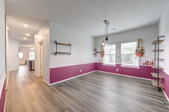 unfurnished dining area featuring hardwood / wood-style flooring