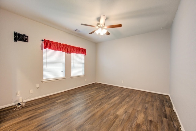 spare room with ceiling fan and dark hardwood / wood-style floors