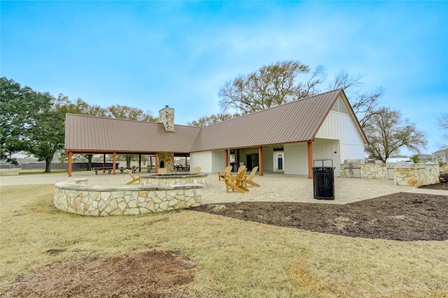 back of property featuring area for grilling, a yard, and a patio area