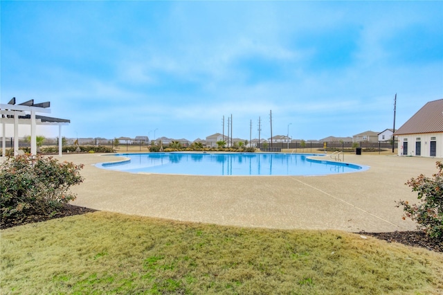 view of pool featuring a pergola, a lawn, and a patio