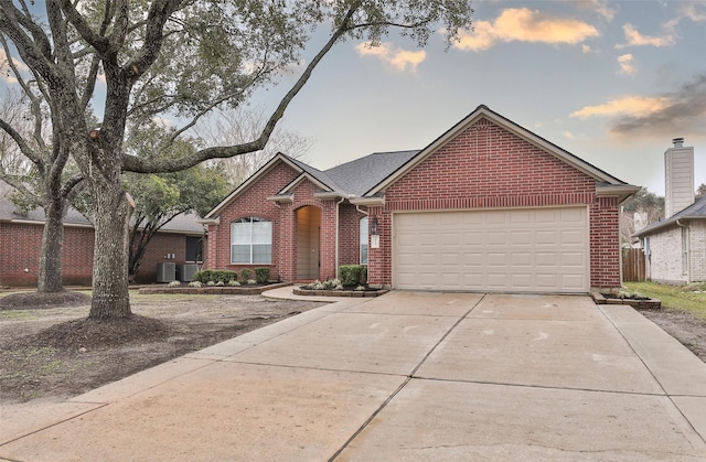 view of front of house featuring a garage and central air condition unit