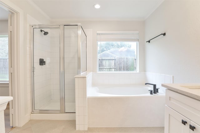 bathroom with ornamental molding, separate shower and tub, and a wealth of natural light