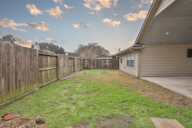 yard at dusk with a patio