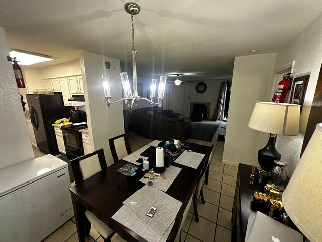 tiled dining area with ceiling fan