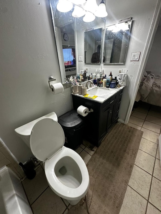 bathroom featuring toilet, tile patterned flooring, and vanity