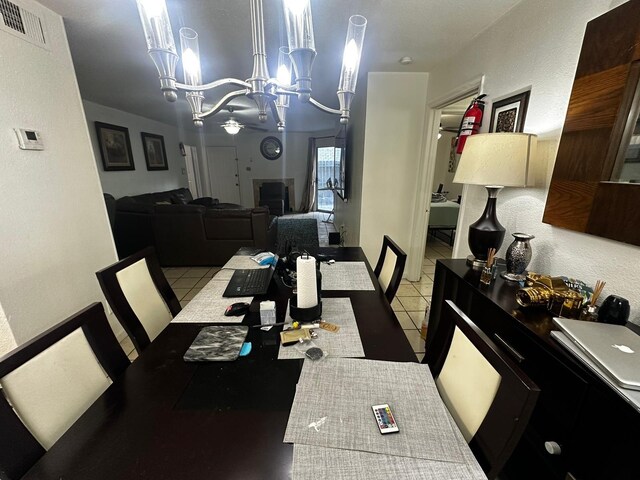 dining room featuring a chandelier and light tile patterned floors