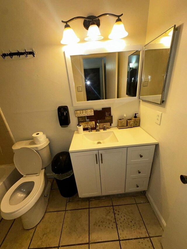 bathroom with a bathtub, toilet, tile patterned flooring, and vanity