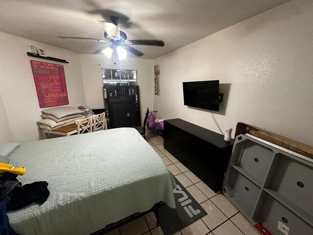 bedroom with ceiling fan and light tile patterned flooring