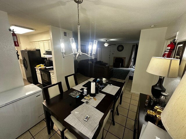 dining room with ceiling fan and light tile patterned floors