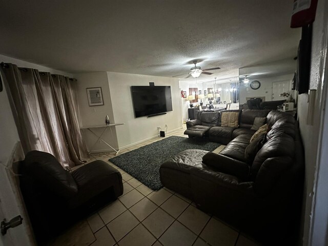 tiled living room with a textured ceiling and ceiling fan