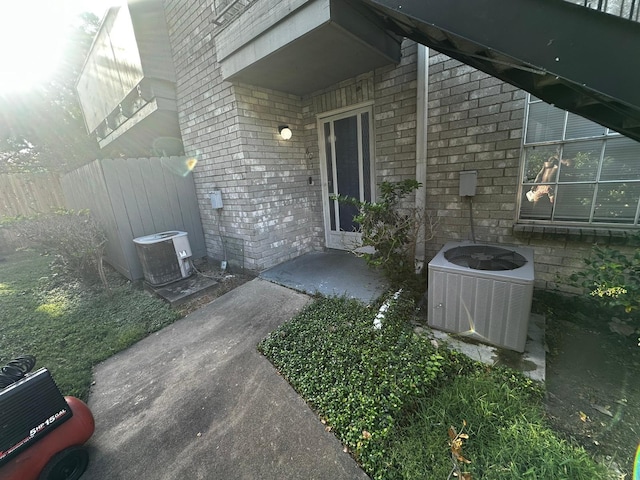 doorway to property featuring central air condition unit