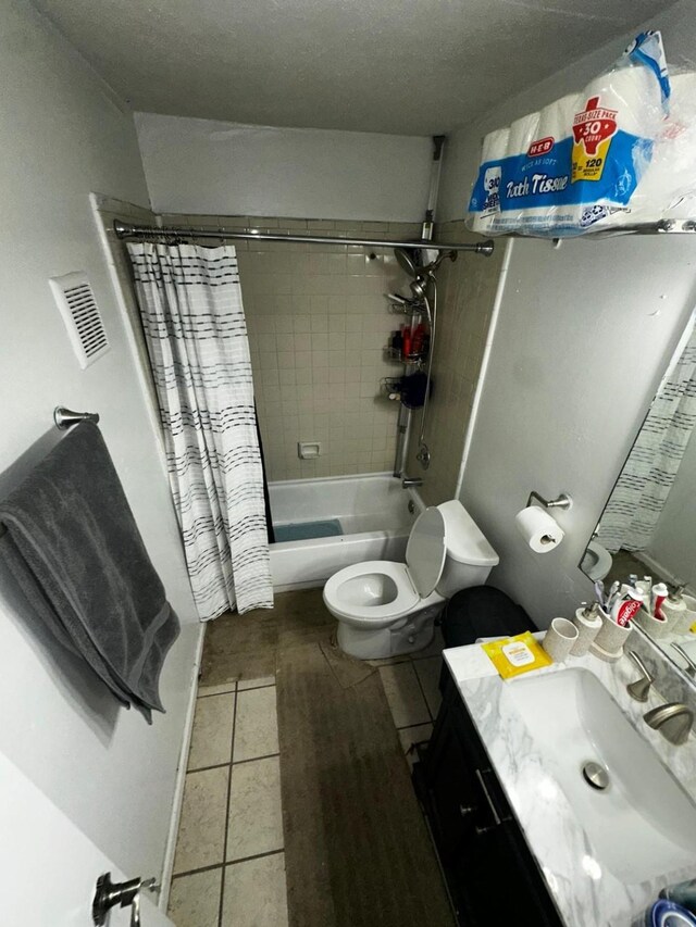 full bathroom featuring toilet, shower / tub combo with curtain, tile patterned floors, and vanity