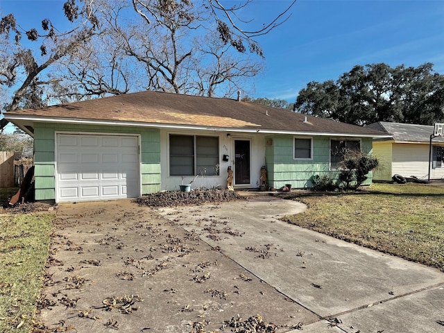 ranch-style house with a garage and a front lawn