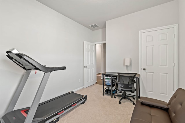 exercise room featuring light colored carpet