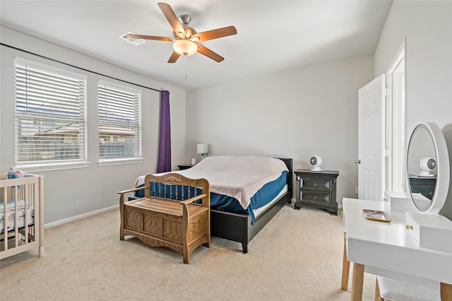 bedroom with light carpet and ceiling fan