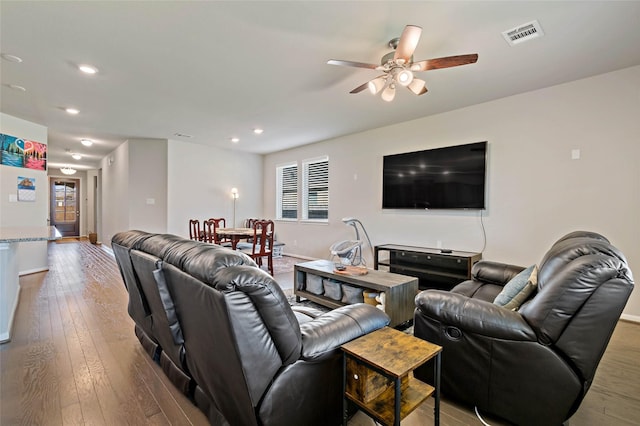 living room featuring ceiling fan and light hardwood / wood-style flooring