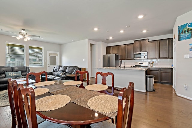 dining room with sink, ceiling fan, and hardwood / wood-style floors