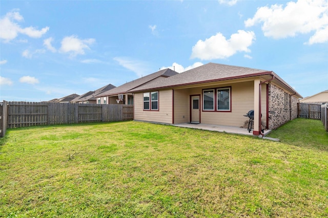 rear view of house with a patio area and a lawn