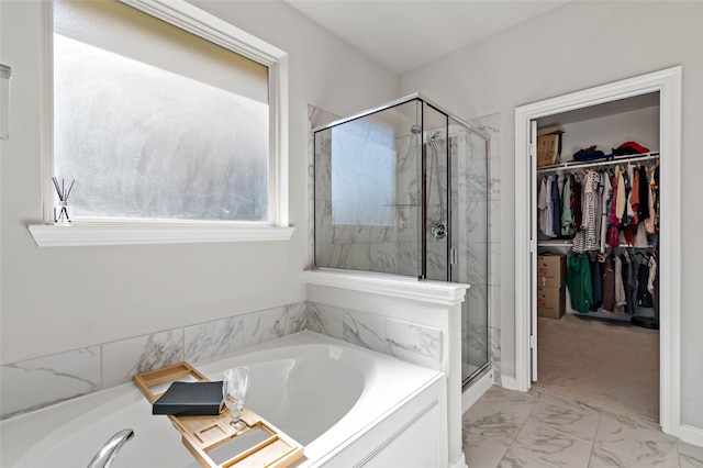 bathroom featuring separate shower and tub