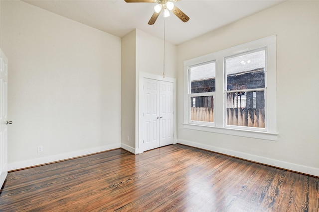 unfurnished room with ceiling fan and dark hardwood / wood-style flooring