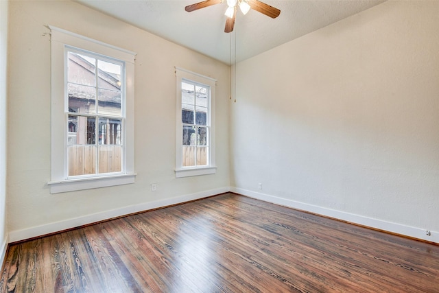 spare room with ceiling fan and wood-type flooring