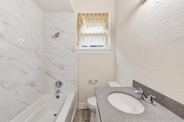 full bathroom featuring vanity, toilet, hardwood / wood-style floors, and tiled shower / bath combo