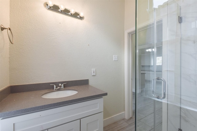 bathroom with an enclosed shower and vanity