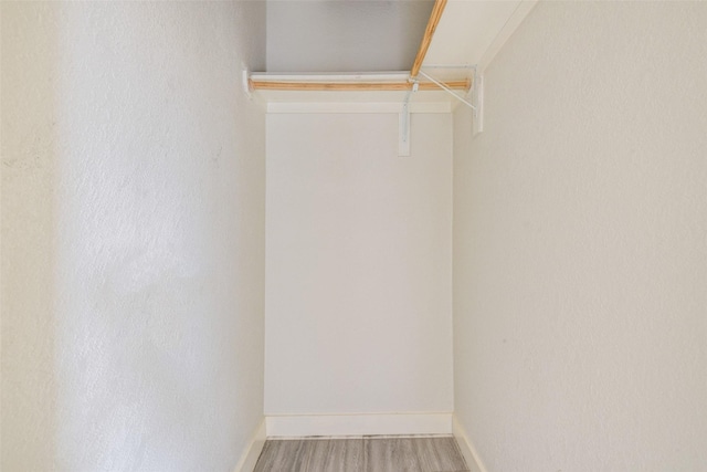 spacious closet featuring hardwood / wood-style floors