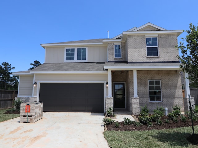 traditional-style home featuring fence, an attached garage, concrete driveway, and brick siding