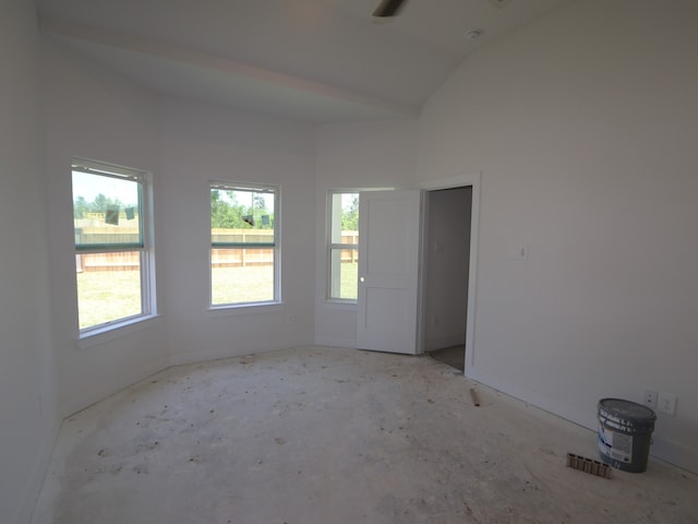 unfurnished room featuring baseboards, vaulted ceiling, ceiling fan, and visible vents