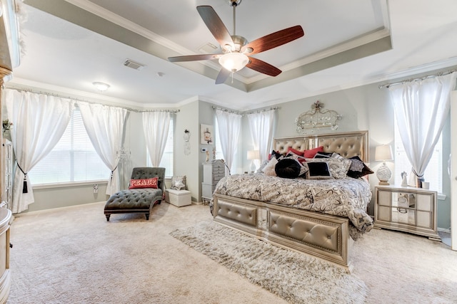 bedroom with ceiling fan, a raised ceiling, crown molding, and carpet floors