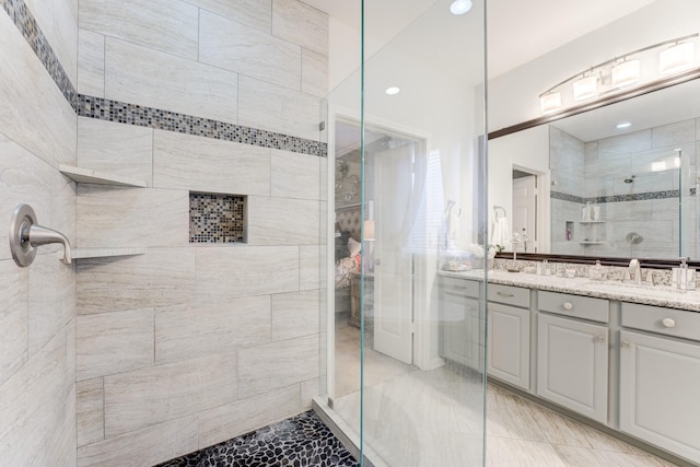 bathroom with walk in shower and vanity