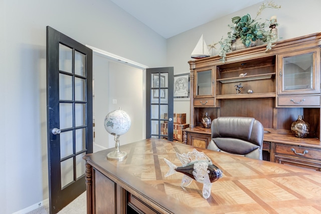 office with french doors and carpet flooring