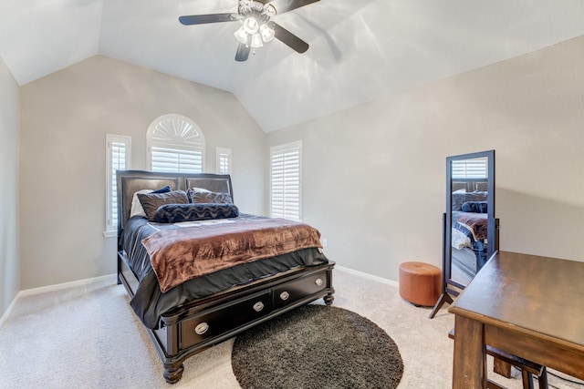 carpeted bedroom featuring ceiling fan, vaulted ceiling, and multiple windows