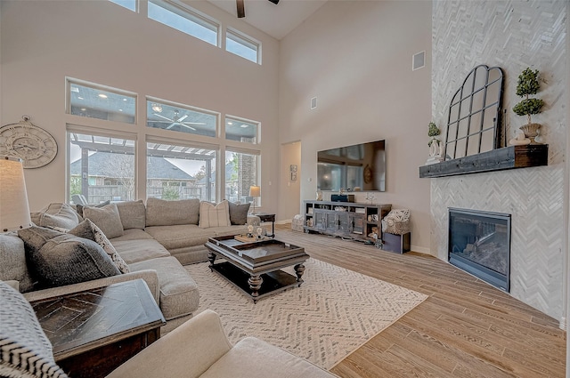 living room featuring a healthy amount of sunlight, hardwood / wood-style floors, and a high ceiling