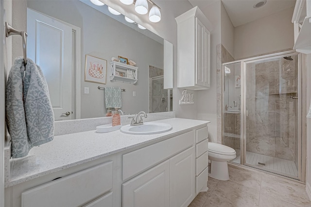 bathroom with tile patterned flooring, vanity, walk in shower, and toilet